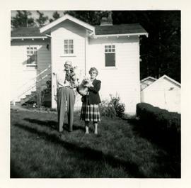 Mr. and Mrs. Massey  holding dogs in front of 81 High Street