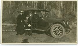 Holland family in front of car; possible identifications (L-R) Aurina, Velda, Fred, Charles